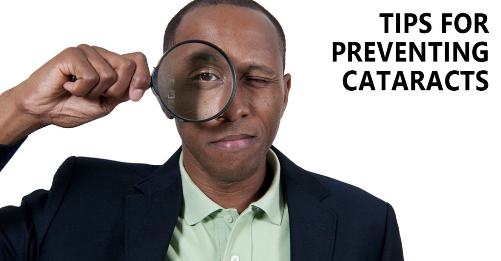 Tips for preventing cataracts. An African American man looking through a magnifying glass.