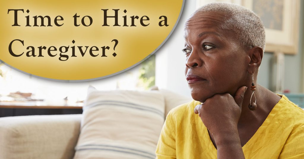 Time to hire a caregiver? African American lady sitting on a sofa.