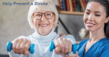 What Can be Done to Prevent a Stroke? Picture of an elderly caucasian female exercising with light dumbbells and with assistance from a hispanic physical therapist.